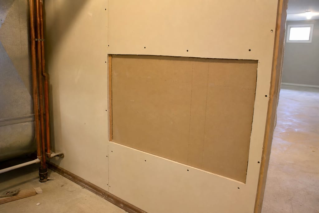 Cut out compromised drywall photo